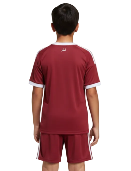 Child wearing a red sports outfit with white accents on a white background